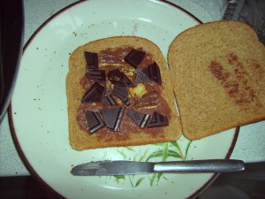 Ingredients of a chocolate toasty. Brown bread, chocolate spread, thin dark chocolate pieces, some chocolate digestive (not enough).